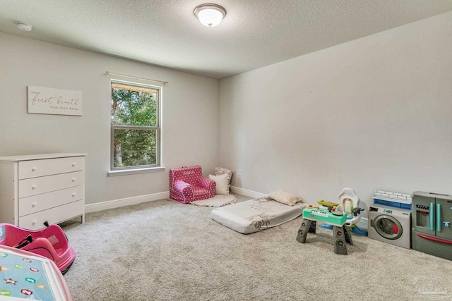 recreation room featuring a textured ceiling and carpet floors