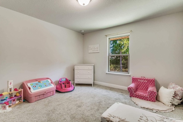 rec room with a textured ceiling and carpet flooring