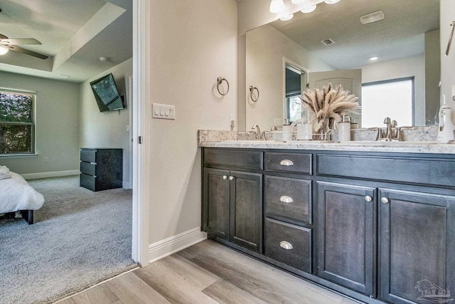 bathroom featuring hardwood / wood-style flooring, ceiling fan, and vanity