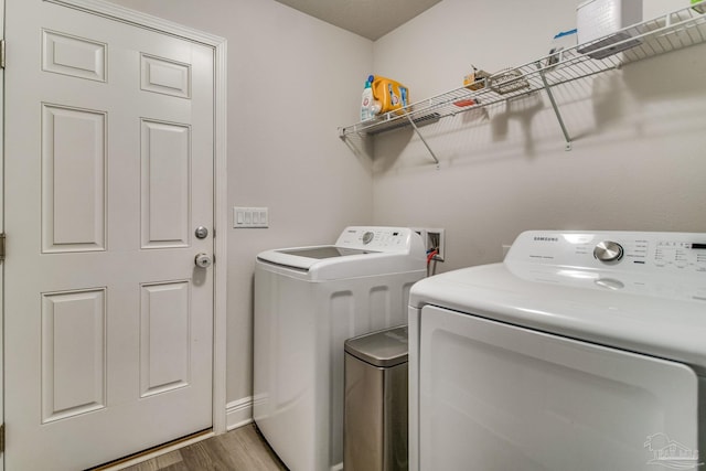 laundry area featuring washer and dryer and wood-type flooring