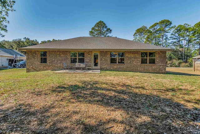 back of property with a patio and a lawn