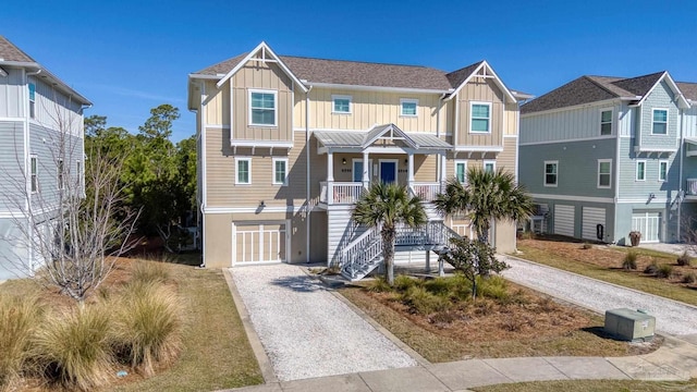 coastal inspired home featuring gravel driveway, a porch, and board and batten siding