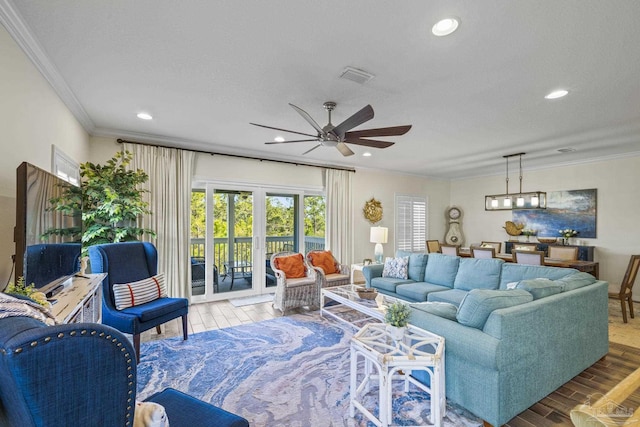 living area with recessed lighting, wood finished floors, visible vents, ornamental molding, and french doors