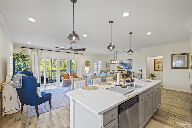 kitchen featuring light wood finished floors, plenty of natural light, dishwasher, gray cabinets, and light countertops