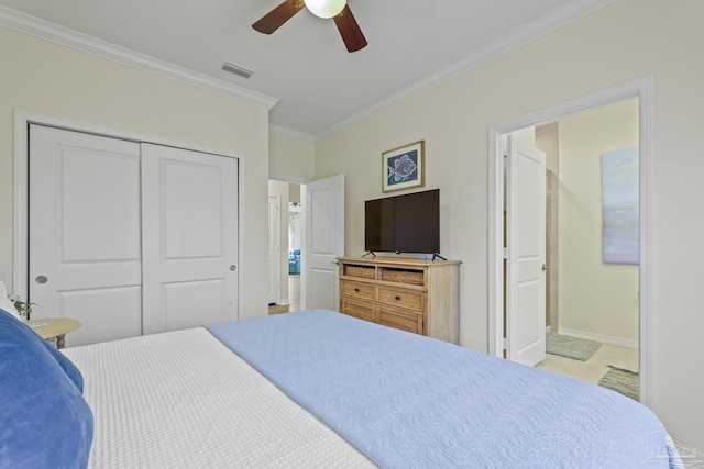 bedroom featuring visible vents, baseboards, ornamental molding, a closet, and ensuite bath