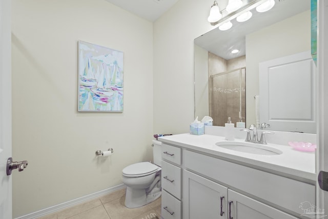 full bath with toilet, vanity, baseboards, a shower stall, and tile patterned floors