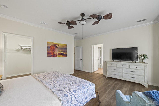 bedroom with dark wood-style floors, ornamental molding, visible vents, and baseboards