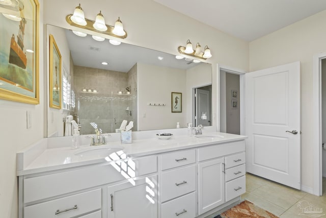 bathroom with tile patterned floors, a sink, a shower stall, and double vanity