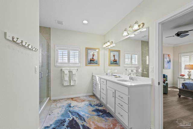 ensuite bathroom featuring visible vents, a stall shower, connected bathroom, a sink, and ceiling fan