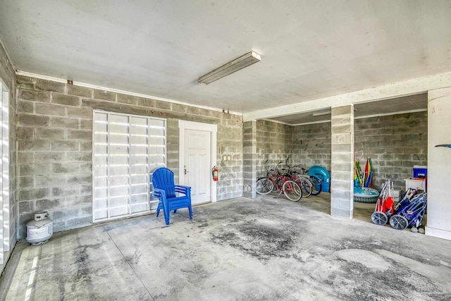 garage with concrete block wall