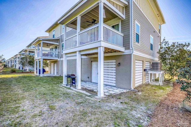 back of house with a ceiling fan, cooling unit, and a garage