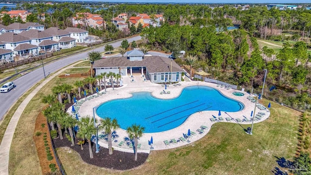 pool featuring a patio area, fence, and a residential view