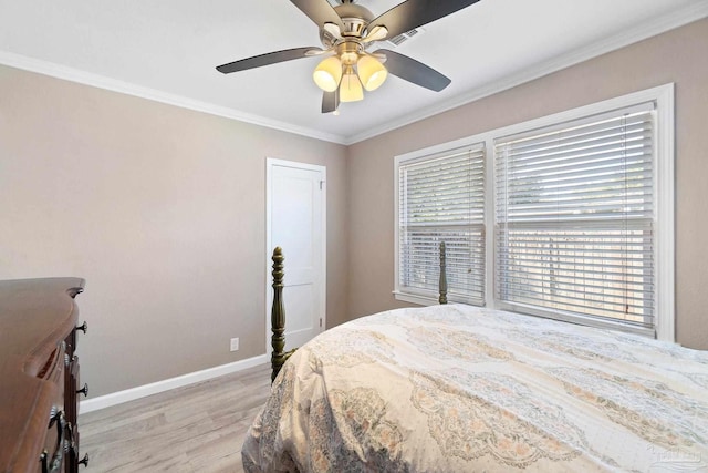 bedroom with crown molding, light hardwood / wood-style floors, and ceiling fan