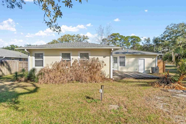 rear view of house featuring a yard, a deck, and central AC unit