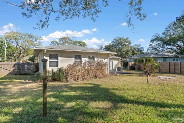 rear view of house with a yard