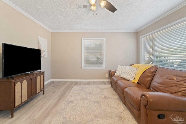 living room with crown molding, a textured ceiling, light wood-type flooring, and ceiling fan