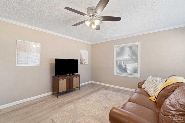 living room with light hardwood / wood-style flooring, ornamental molding, a textured ceiling, and ceiling fan