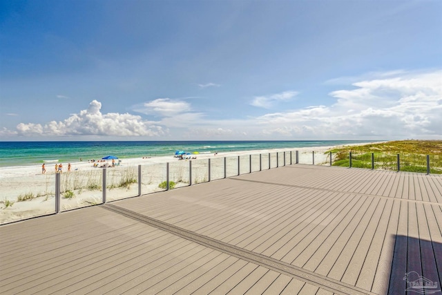 wooden deck with a view of the beach and a water view