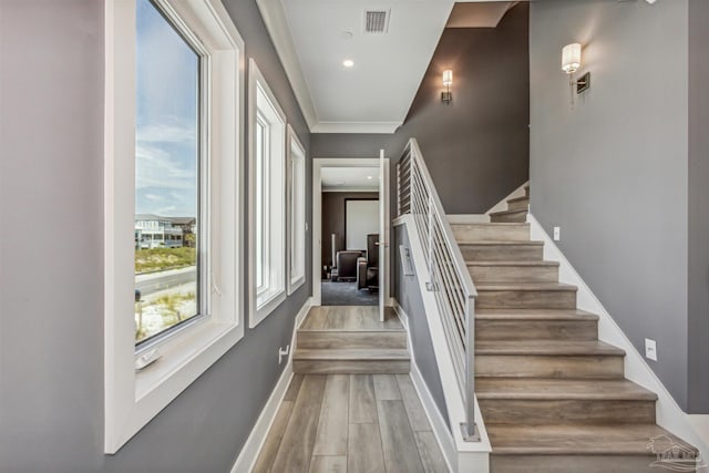 stairs featuring hardwood / wood-style floors