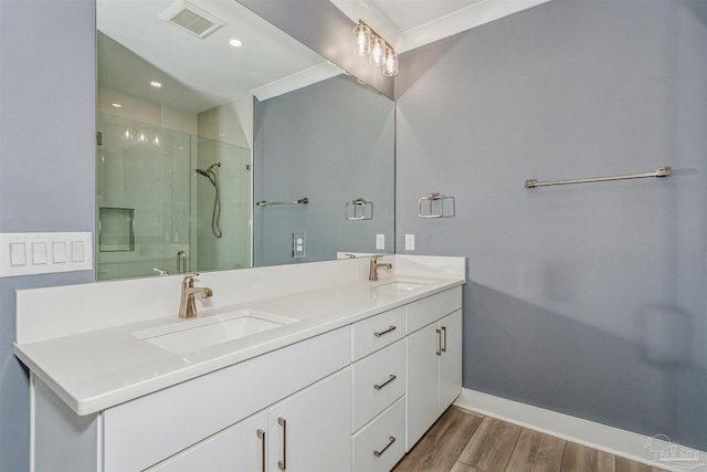 bathroom featuring walk in shower, wood-type flooring, and vanity