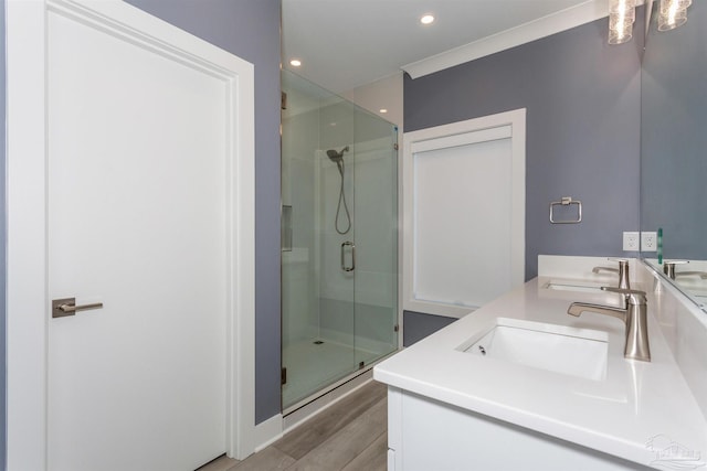 bathroom with vanity, a shower with shower door, and wood-type flooring