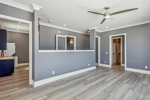 unfurnished living room with ornamental molding, ceiling fan, and light wood-type flooring