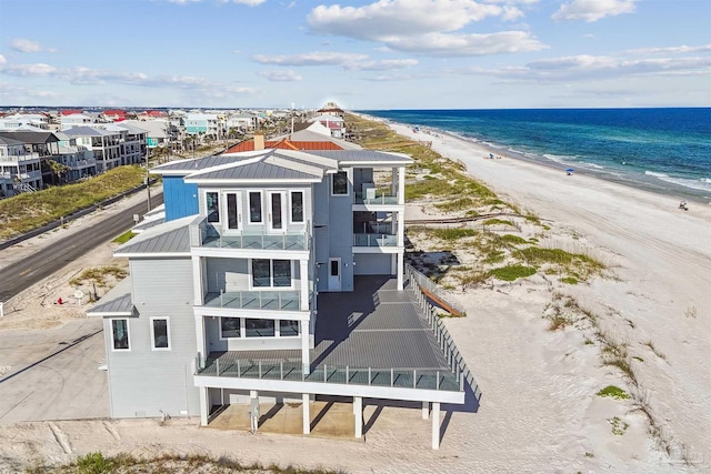 drone / aerial view featuring a water view and a beach view