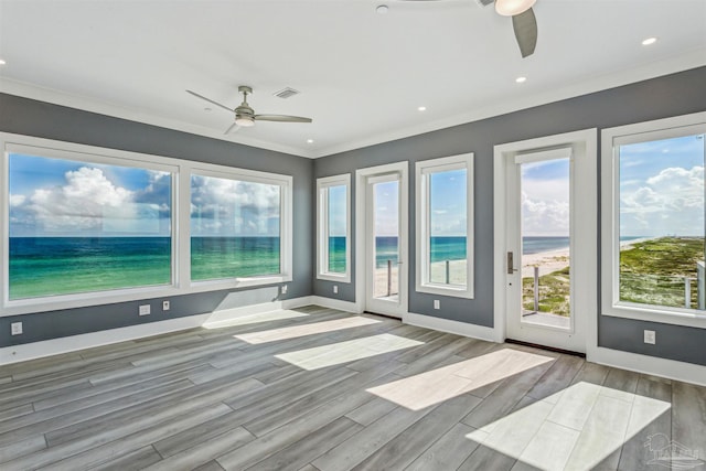 interior space with ceiling fan and a water view