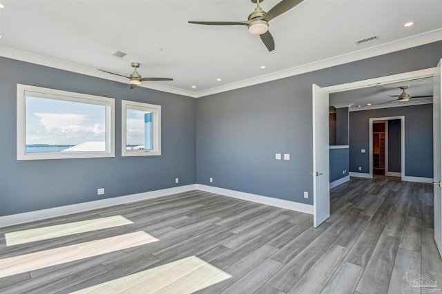 spare room with wood-type flooring, ornamental molding, and ceiling fan