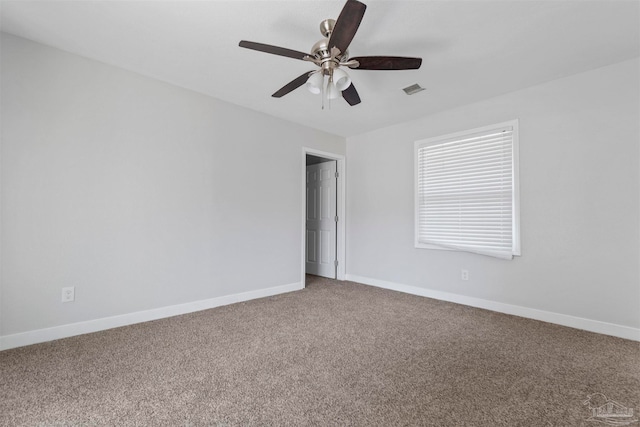 carpeted spare room with ceiling fan