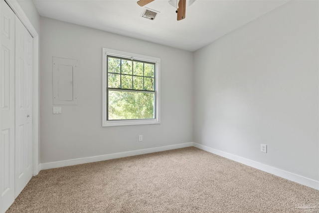 carpeted empty room featuring electric panel and ceiling fan