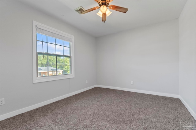 empty room featuring ceiling fan and carpet