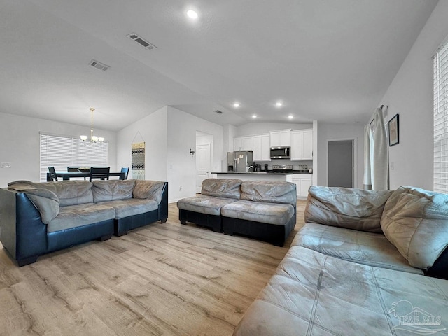 4695 Perception Cir, Milton, FL 32570 - living room featuring light wood-style floors, a chandelier, lofted ceiling, and recessed lighting