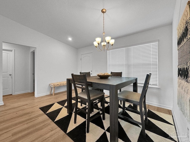 4695 Perception Cir, Milton, FL 32570 - dining space with light wood-style flooring, a chandelier, baseboards, recessed lighting, and a textured ceiling