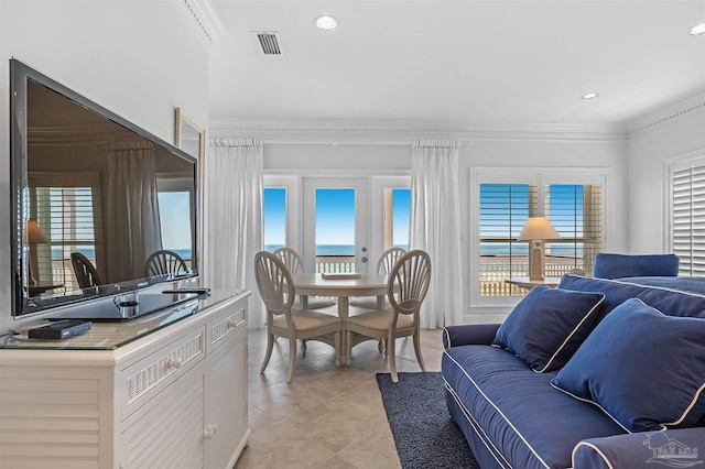 interior space featuring ornamental molding and light tile patterned floors