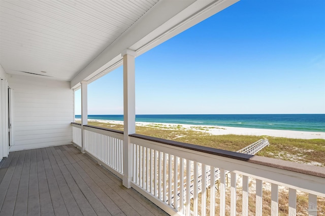 wooden terrace with a water view and a beach view