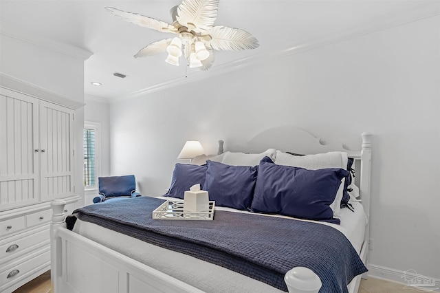 bedroom with ceiling fan and ornamental molding