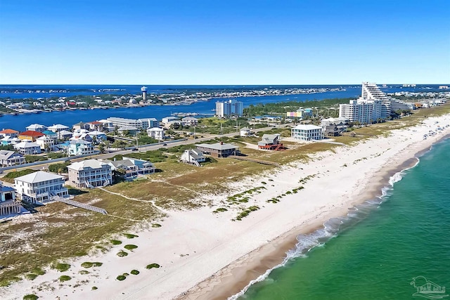 drone / aerial view with a water view and a beach view