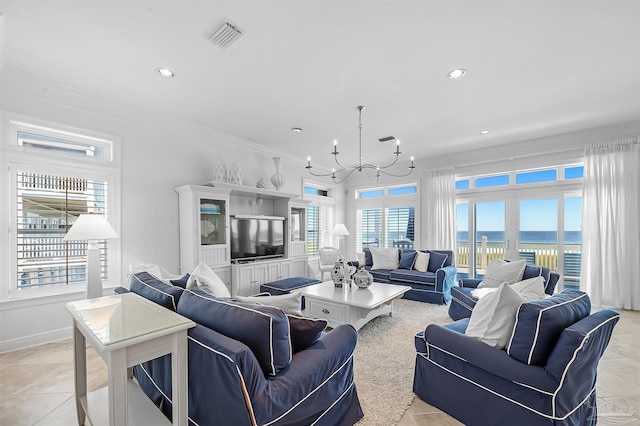 tiled living room with crown molding, a healthy amount of sunlight, and a notable chandelier