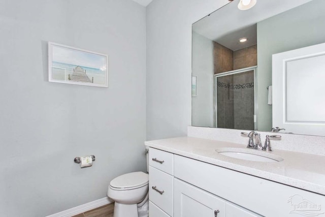 14390 Cordgrass Ln, Pensacola, FL 32507 - full bathroom featuring vanity, wood finished floors, baseboards, a shower stall, and toilet