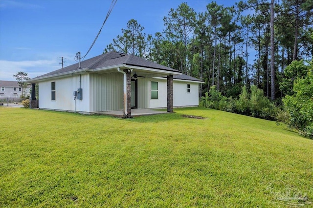 rear view of property with a yard