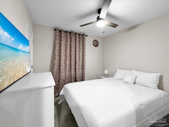 carpeted bedroom featuring a textured ceiling and ceiling fan