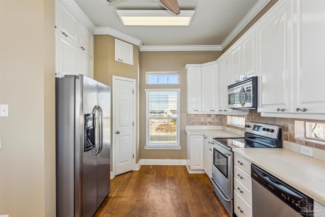 kitchen featuring backsplash, white cabinetry, and stainless steel appliances