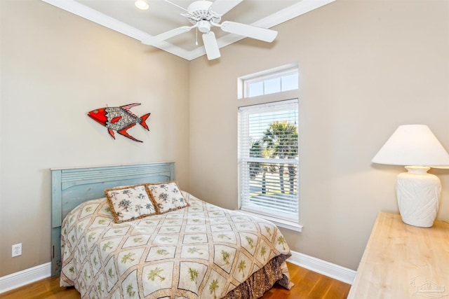 bedroom with hardwood / wood-style flooring, ceiling fan, and ornamental molding