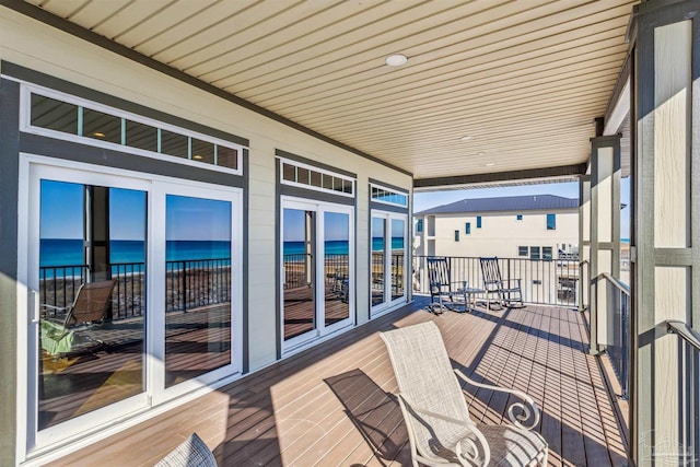 wooden deck featuring a water view