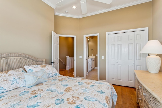 bedroom featuring ceiling fan, a closet, light hardwood / wood-style flooring, and ornamental molding