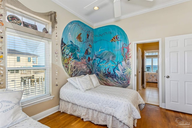 bedroom with multiple windows, hardwood / wood-style flooring, ceiling fan, and crown molding