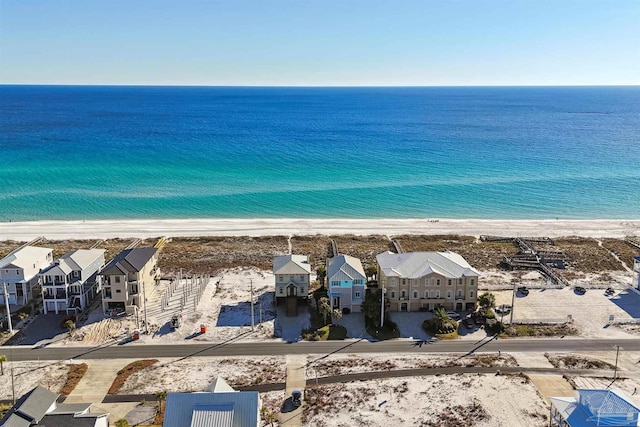 drone / aerial view featuring a water view and a view of the beach