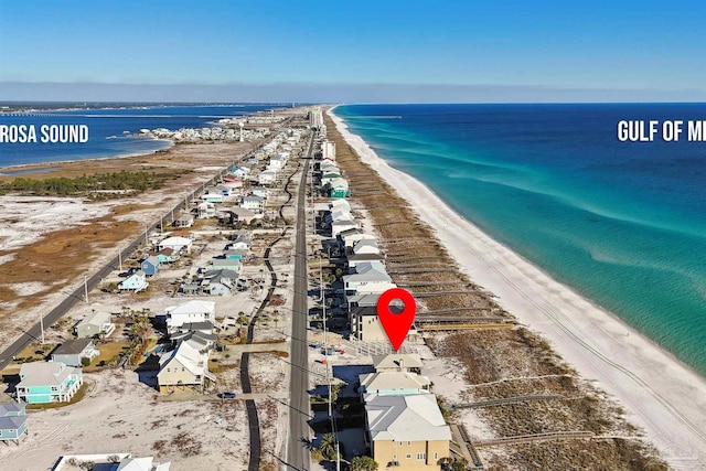 birds eye view of property with a view of the beach and a water view