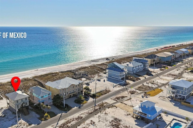 bird's eye view featuring a water view and a beach view